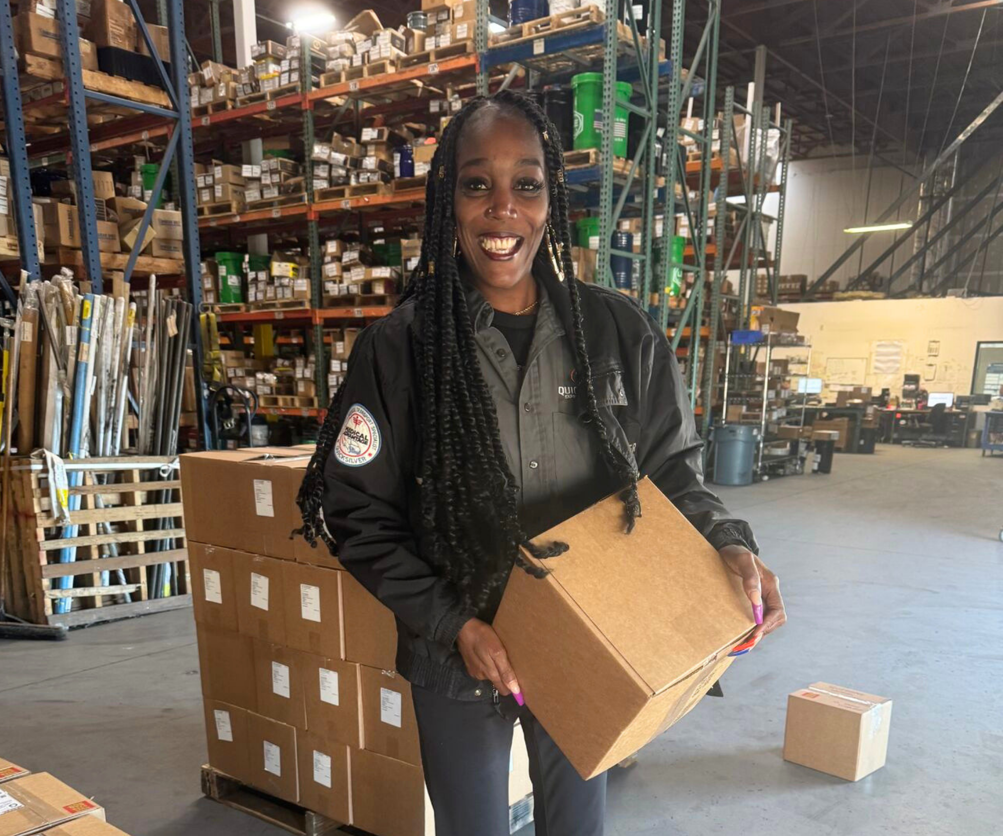 Quicksilver driver holding a box